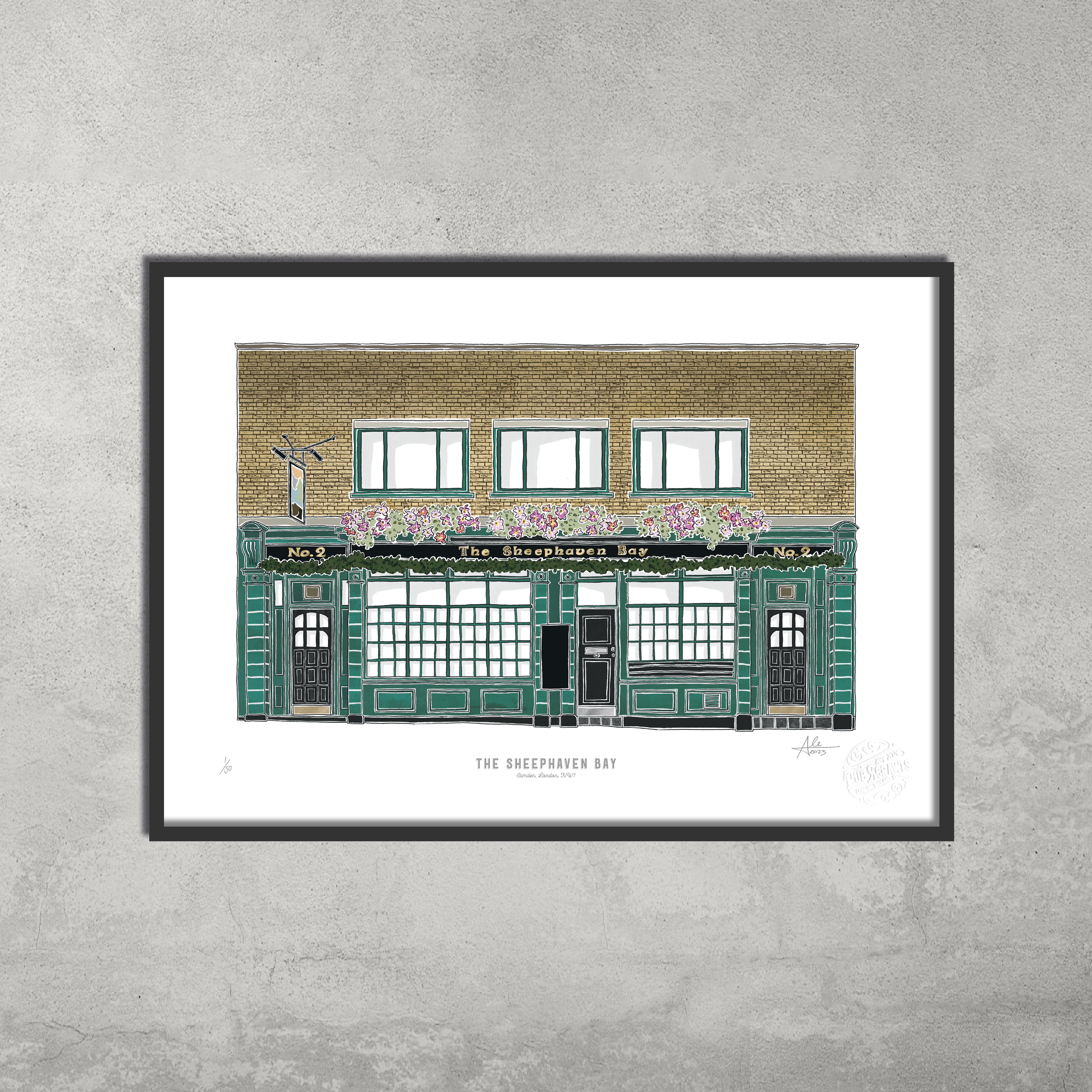The Sheephaven Bay – Limited Edition of 50 A3 Colour Prints by 45 Original depicts the pub’s green exterior with flower boxes and large front windows—perfect for Hampstead & Highgate Pub Crawl fans. Shown on a gray concrete wall.