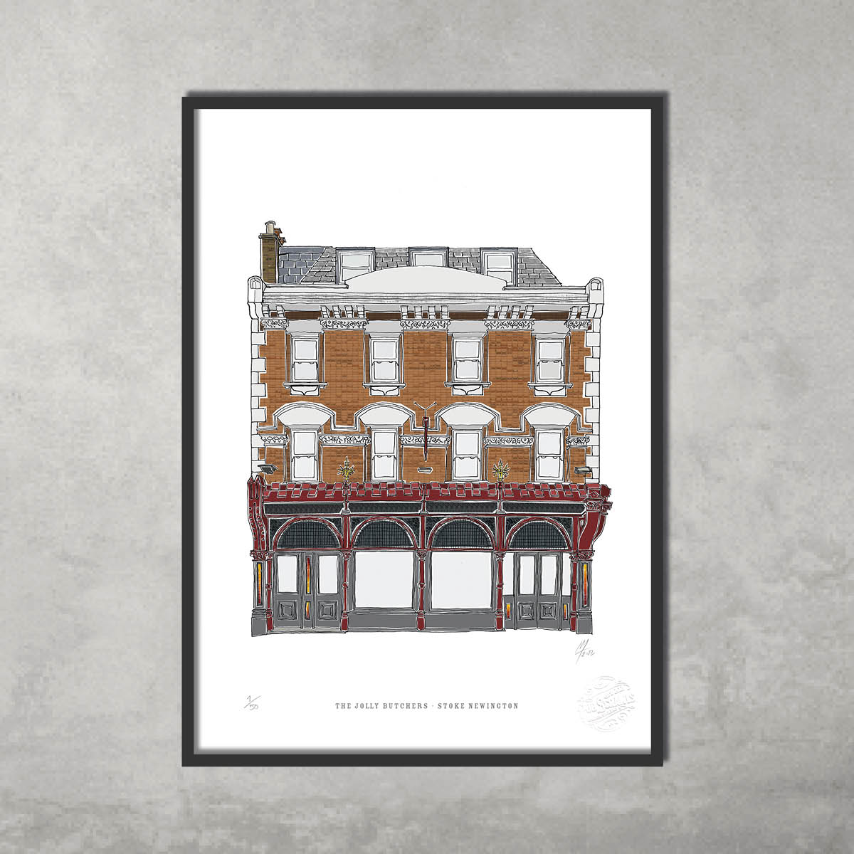 The Jolly Butchers – Limited Edition of 50 A3 Colour Prints by 45 Original depicts a Victorian pub with ornate red trim, perfect for fine art fans or Hackney Pub Crawl lovers. Framed and displayed on a plain gray wall.