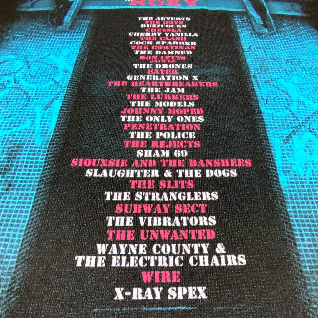 A close-up of the My Store Roxy Club T-Shirt—Limited Edition of Only 100—shows punk band names in red and white on black fabric, with blue lighting inspired by the iconic London venues legendary nights.